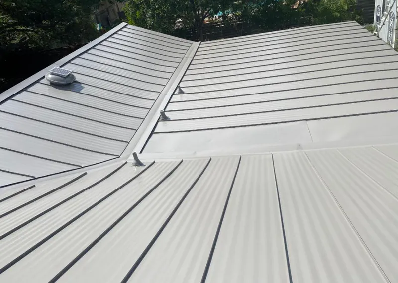 Solar attic fan installed on a metal roof for Roof Ventilation in Winthrop Harbor